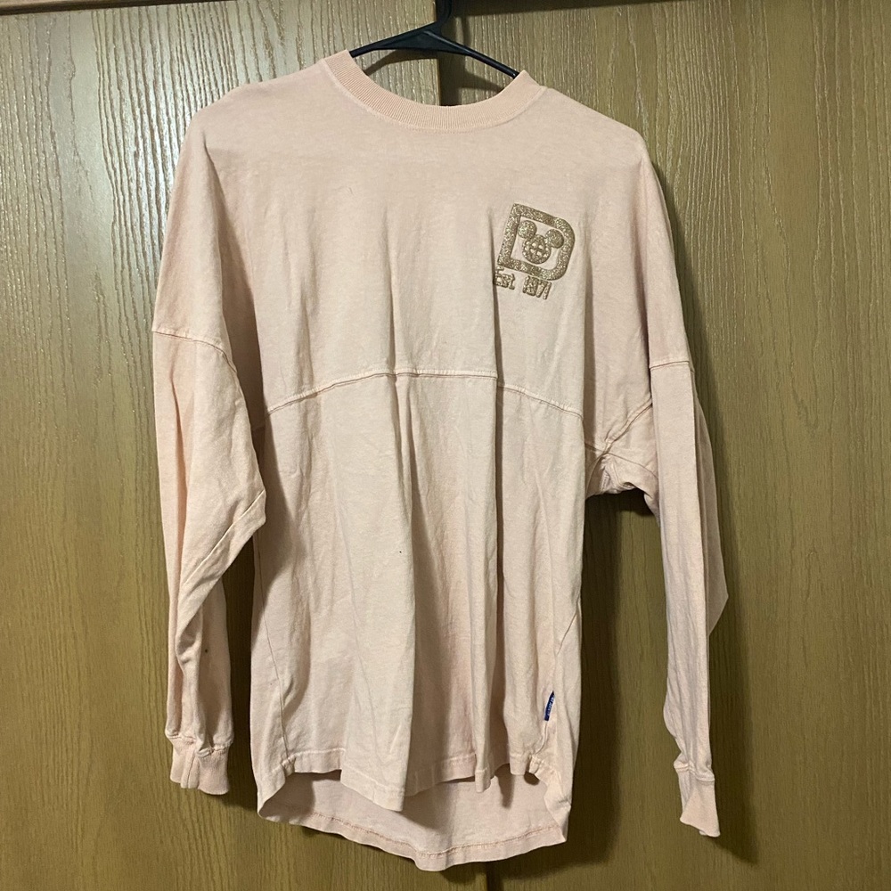 Pink Disney shirt with logo on the front on Walt Disney world on the back
